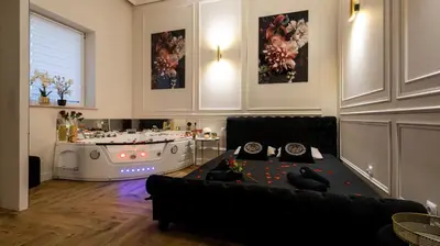 a living room with a couch and a hot tub at Vistula Boulevards Jacuzzi Apartment in Kraków