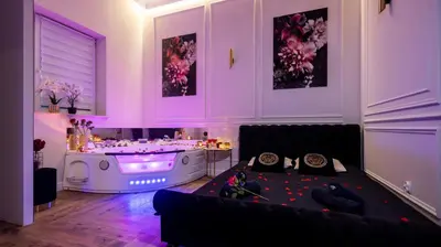 a living room with a couch and a tub at Vistula Boulevards Jacuzzi Apartment in Kraków