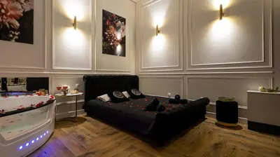 a living room with a couch and a video game at Vistula Boulevards Jacuzzi Apartment in Kraków