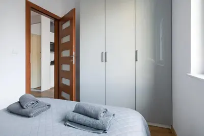 a bedroom with a bed with towels on it at Modern and comfortable with a bedroom in Kraków