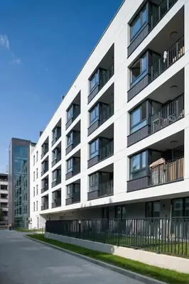 a white building with balconies on the side of it at Modern and comfortable with a bedroom in Kraków