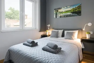 a bedroom with a bed with two towels on it at Modern and comfortable with a bedroom in Kraków