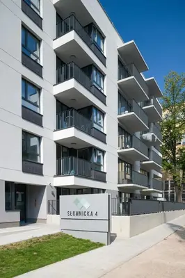 a building with a sign in front of it at Modern and comfortable with a bedroom in Kraków