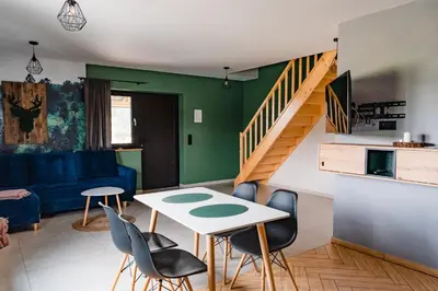 a living room with a table and chairs at NOVMI - Domki letniskowe