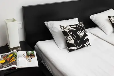 a bedroom with two beds and a book on the bed at Cosy Corner - Kraków, Krowodrza - by Upstairs in Kraków