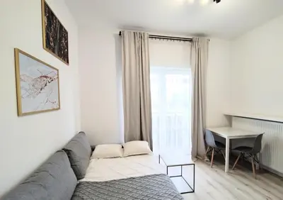 a living room with a couch and a table at White Studio in Wieliczka