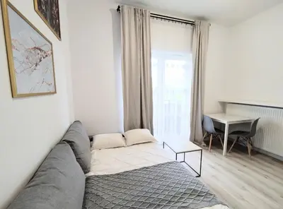 a living room with a couch and a table at White Studio in Wieliczka