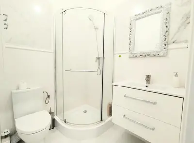 a bathroom with a shower and a toilet and a sink at White Studio in Wieliczka