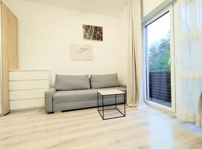 a living room with a couch and a window at White Studio in Wieliczka