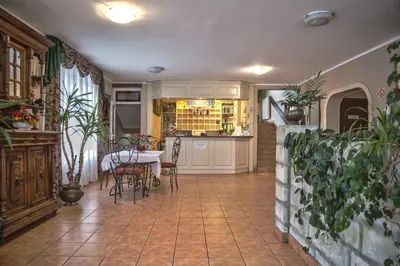 a kitchen and dining room with a table and chairs at Gościniec nad Zalewem Sosina in Jaworzno