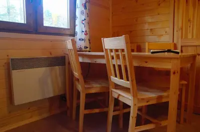 a room with a table and two chairs and a desk at Gościniec nad Zalewem Sosina in Jaworzno