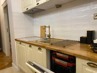 a kitchen with a sink and a counter top at Radiance Residence in Kraków