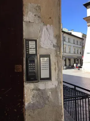 a pay phone on the side of a building at Radiance Residence in Kraków