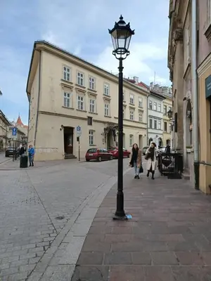a street light on a city street with buildings at Radiance Residence in Kraków