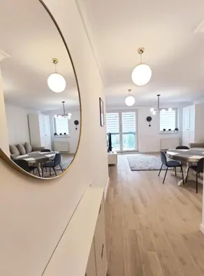 a living room with a mirror on the wall at Sołtysa Dytmara 3 by Homeprime in Kraków
