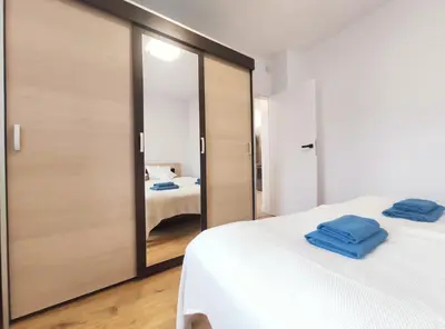 a room with two beds and a sliding glass door at Sołtysa Dytmara 3 by Homeprime in Kraków
