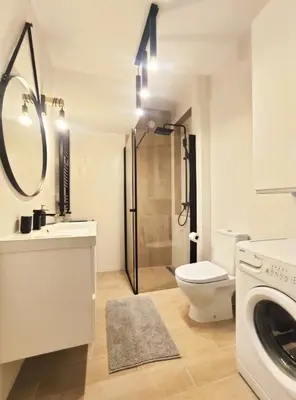 a bathroom with a toilet sink and a shower at Sołtysa Dytmara 3 by Homeprime in Kraków