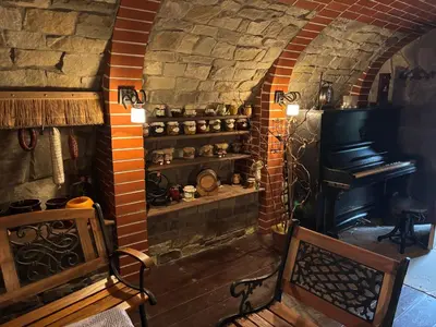 a stone room with a stove and a bench at Koperkowe Rancho Beskid Wyspowy Domek Małopolskie KAMIONNA in Kamionna