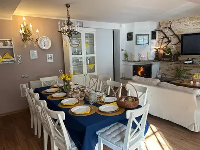 a dining room with a blue table with chairs and a fireplace at Koperkowe Rancho Beskid Wyspowy Domek Małopolskie KAMIONNA in Kamionna