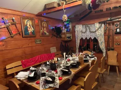 a dining room with a long wooden table with food at Koperkowe Rancho Beskid Wyspowy Domek Małopolskie KAMIONNA in Kamionna