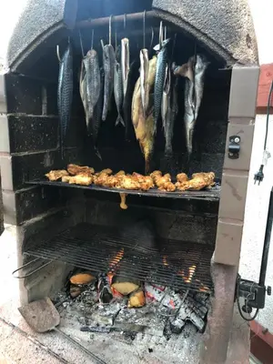 a grill with a bunch of fish on it at Koperkowe Rancho Beskid Wyspowy Domek Małopolskie KAMIONNA in Kamionna