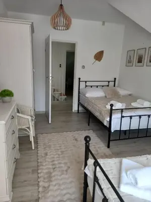 a bedroom with two beds and a room with a hallway at Koperkowe Rancho Beskid Wyspowy Domek Małopolskie KAMIONNA in Kamionna