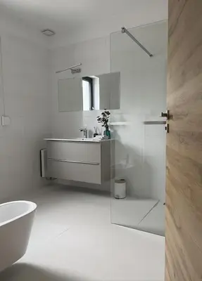 a white bathroom with a sink and a shower at Dom nad Stryszawką z SAUNĄ - domek wypoczynkowy in Stryszawa