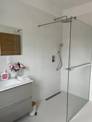 a white bathroom with a shower and a sink at Dom nad Stryszawką z SAUNĄ - domek wypoczynkowy in Stryszawa