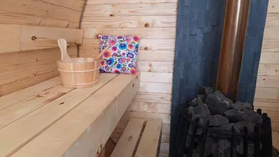 a wooden sauna with a bucket and a pillow at Dom nad Stryszawką z SAUNĄ - domek wypoczynkowy in Stryszawa