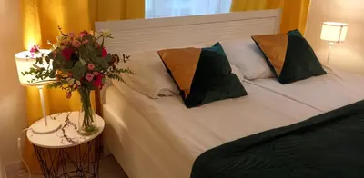 a small kitchen with a bed in a room at Central Cracow Apartments in Kraków