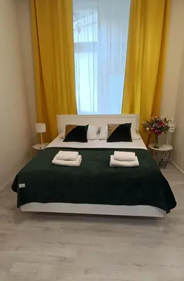 a kitchen with a table with a vase of flowers on it at Central Cracow Apartments in Kraków