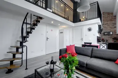 a living room with a couch and a glass table at Apartament Romantyczny Zamkowa15 in Kraków