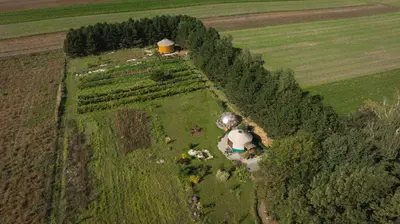 an aerial view of a farm with a barn and trees at Jurta Jura polna in Przybysławice