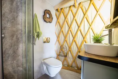 a bathroom with a toilet and a sink at Jurta Jura polna in Przybysławice