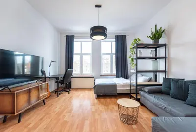 a living room with a couch and a bed at Lubomirskiego 9 in Kraków