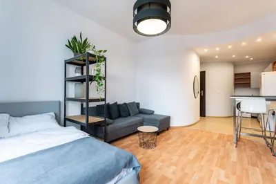 a bedroom with a bed and a couch and a table at Lubomirskiego 9 in Kraków