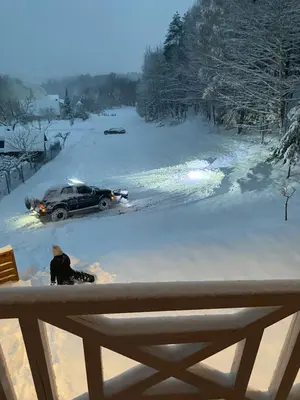 a person sitting in the snow in front of a car at Forest house in Targanice