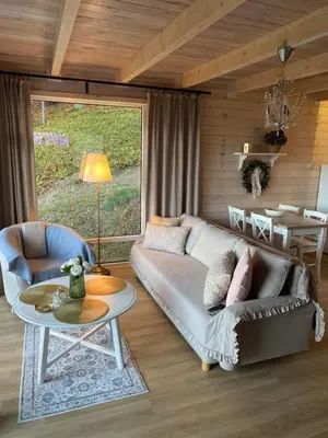 a living room with a couch and a table at Forest house in Targanice
