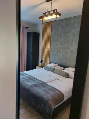 a bedroom with a large bed in a mirror at Zasankowe Wzgórze in Zasań