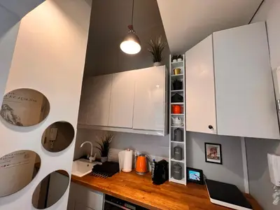 a kitchen with white cabinets and a laptop on a counter at Jewish District in Krakow/ Kraków Kazimierz in Kraków