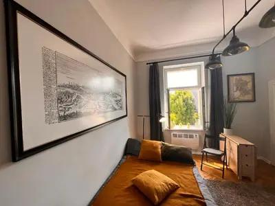 a bedroom with a bed and a picture on the wall at Jewish District in Krakow/ Kraków Kazimierz in Kraków