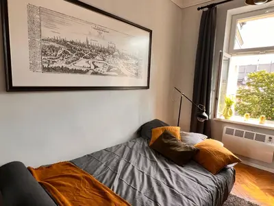 a living room with a couch and a picture on the wall at Jewish District in Krakow/ Kraków Kazimierz in Kraków