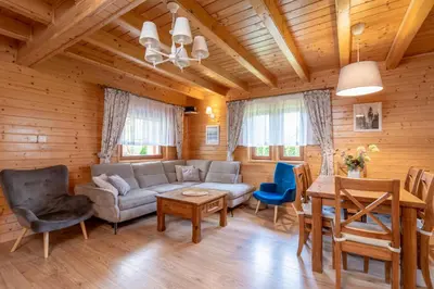 a living room with a couch and a table at Kamyczkowy domek w Zawoi in Zawoja