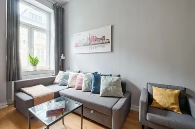 a living room with a couch and a glass table at Urban Nest Apartments Krakowska 10 in Kraków