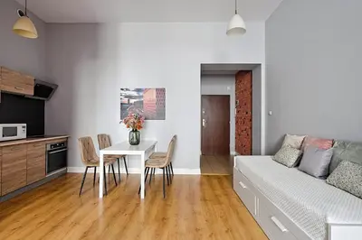 a living room with a couch and a table and chairs at Urban Nest Apartments Krakowska 10 in Kraków