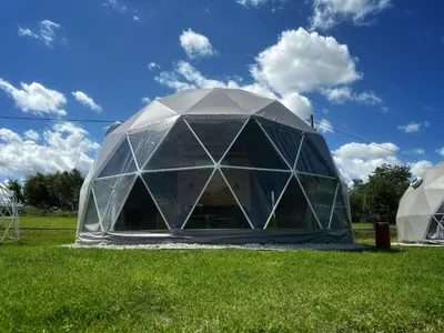 a large dome tent in a field of grass at Glamp Delux Ojcowski Park Narodowy in Wola Kalinowska