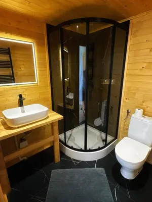 a bathroom with a shower and a toilet and a sink at Glamp Delux Ojcowski Park Narodowy in Wola Kalinowska