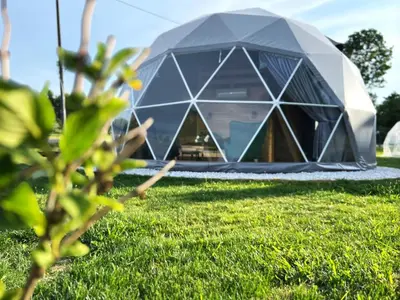 a dome house in a field of grass at Glamp Delux Ojcowski Park Narodowy in Wola Kalinowska