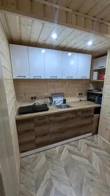 a wooden house with a staircase and a tv at Domek wypoczynkowy Górskie Zacisze in Sidzina