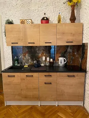 a kitchen with a large wooden counter top at Small room for short stay in Kraków